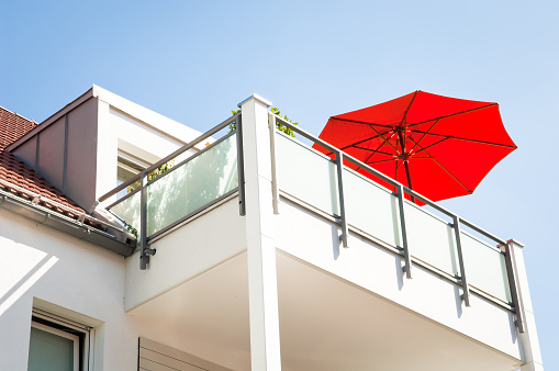 red sunshade at a modern balcony