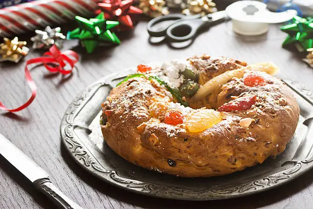 A popular cake during the Christmas season, Bolo do Rei (or Bolo Rei) is round with a hole in the center and both topped and filled with candied fruit and nuts. Usually a single dried fava bean is baked into the cake and the person who gets this bean in their slice is considered the winner. This person usually gets some sort of prize as well as having to be the one to buy the next year's Bolo Rei. 