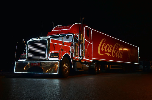 Warsaw, Poland - December 13 th, 2014: Freightliner Coca Cola truck stopped on the parking after the advertisement Coca-Cola exposition on the Christmas market at night in Warsaw.