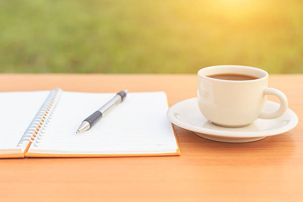 istock Close up coffee cup and notebook on the table 530099955