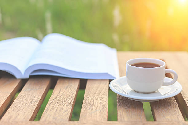 istock Coffee cup and book on the table in the morning 530100665