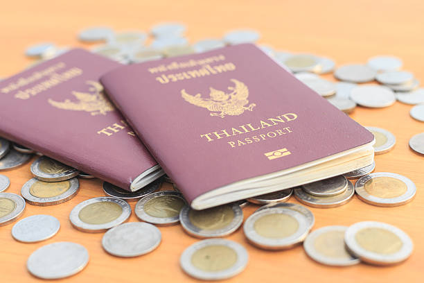 istock Close up Thailand passport and coin on the table 530100689