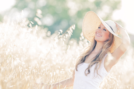 portrait of beautiful woman with summer hat, selective focus, vintage color editing, 