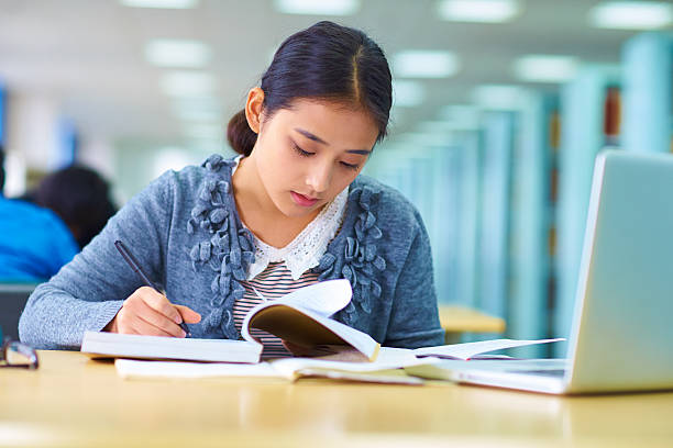 istock pretty asian college student study in the library 530102855