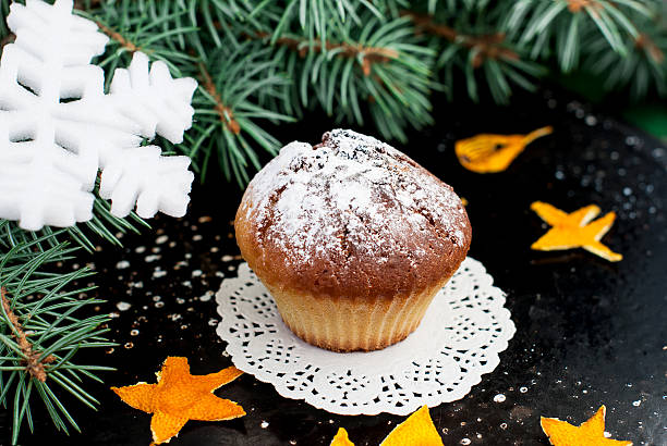 istock Homemade muffins with powdered sugar on a dark background 530115871