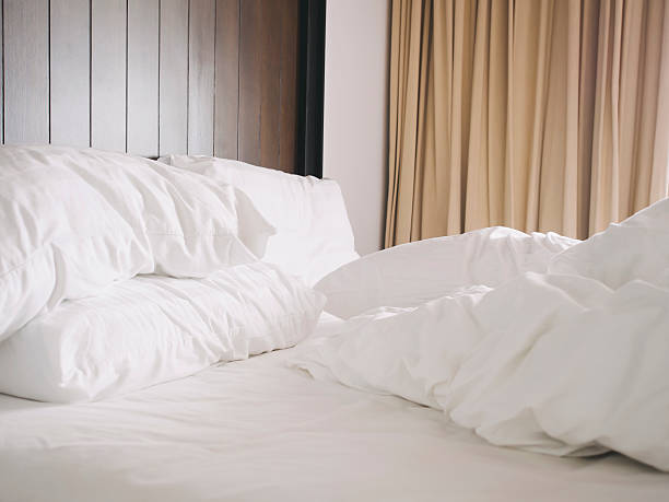 istock Unmade bed and pillows messed up in the morning 530116223