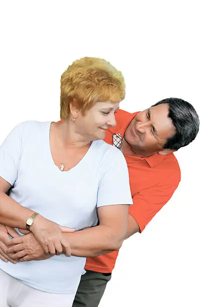 Elderly couple embrace each other . Isolated over white.
