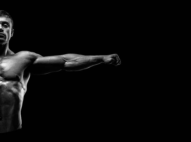 istock Handsome muscular bodybuilder posing and keeping arms outstretch 530117871