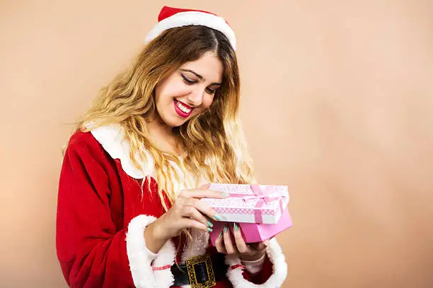 Happy Mrs.Claus opening gift box and smiling