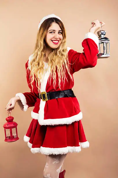 Happy Mrs.Claus holding christmas lamps
