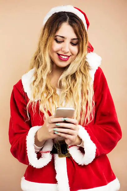 Happy Mrs.Claus text messaging with mobile phone
