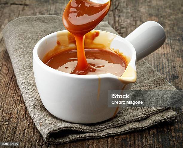 Bowl Of Caramel Sauce Stock Photo - Download Image Now - Caramel, Making, Spoon