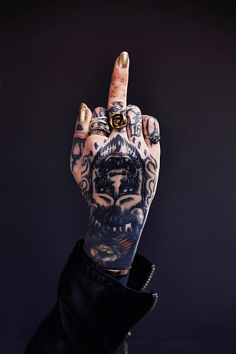 Shot of a tattooed woman giving the finger to the camerahttp://195.154.178.81/DATA/shoots/ic_784263.jpg