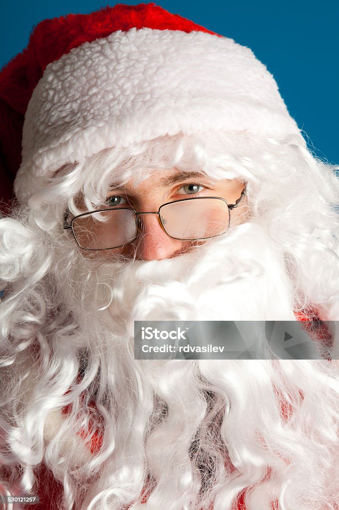 Santa Claus with red costume Santa Claus with red costume. Studio shot. Blue background Adult Stock Photo