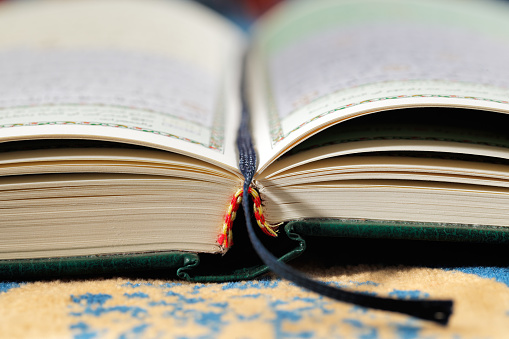 Open book of Holy Bible The Book of NEHEMIAH and black pen with bokeh for background and inspiration