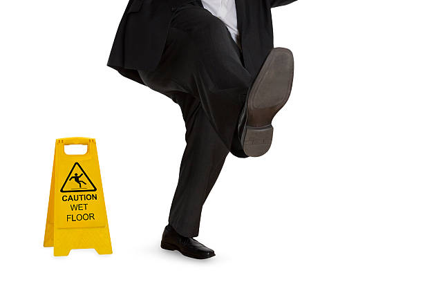 istock Man in suit slipping on wet floor 530122791