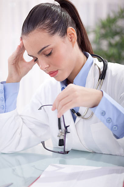 istock young doctor in a stressful situation has a headache 530157105