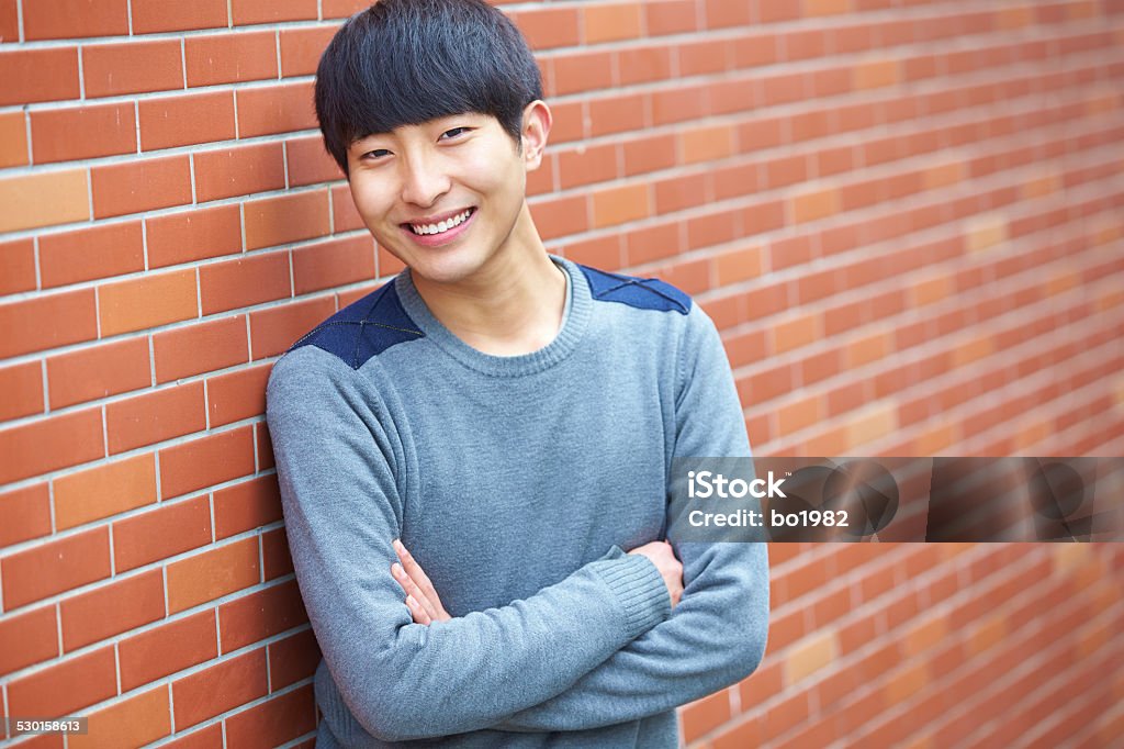 portrait of young asian man smile at camera portrait of young asian man smile at camera  20-24 Years Stock Photo