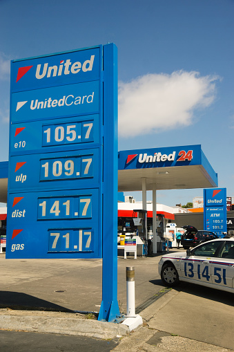 Sydney, Australia - December 25, 2014: A taxi turns into a United Petroleum Station on Victoria Rd, with the price board displaying the lowest petrol prices seen in four years.
