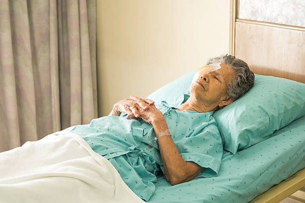 istock Elder female with eye patch sleeping after cataract surgery 530163901
