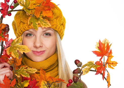 Young woman in hat and scarf with autumn bouquet