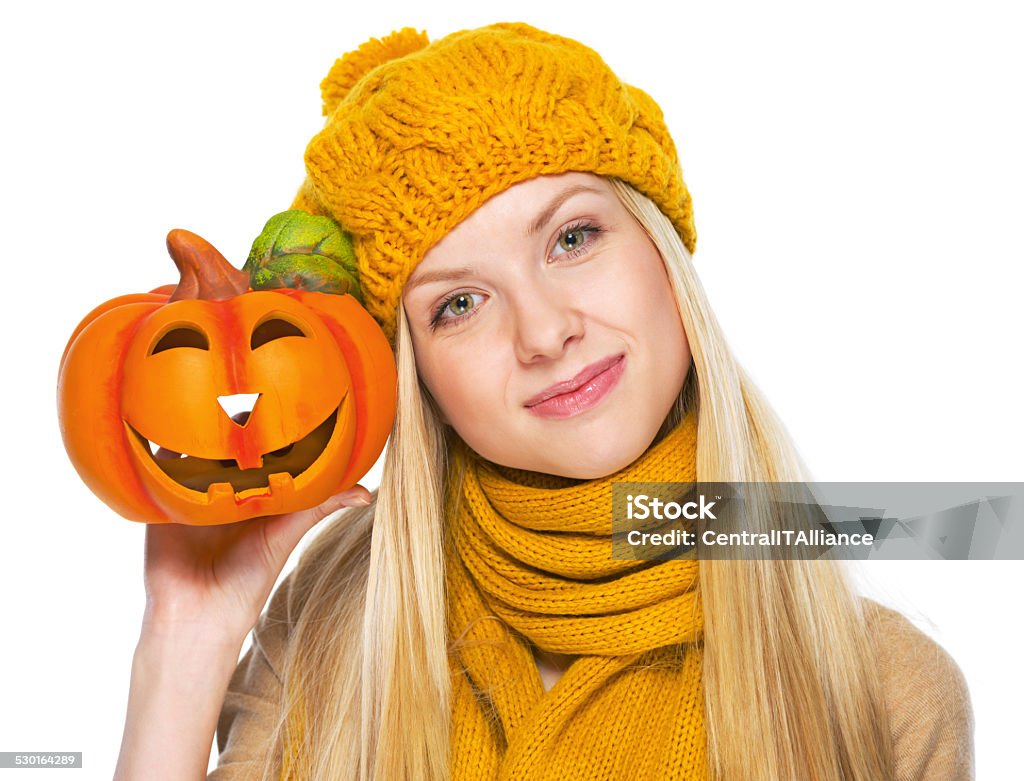 girl in hat and scarf showing jack-o-lantern Girl in hat and scarf showing jack-o-lantern Adult Stock Photo