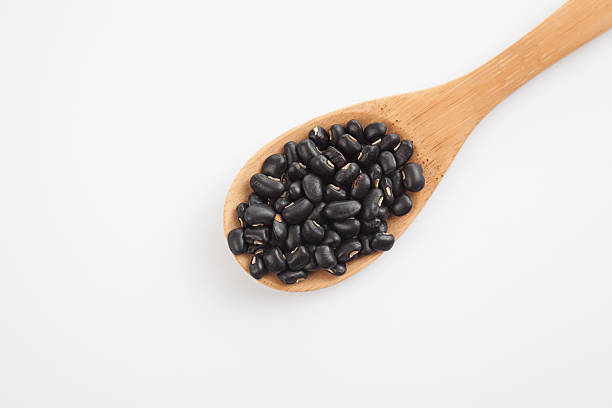 istock Black beans with wooden spoon 530180915