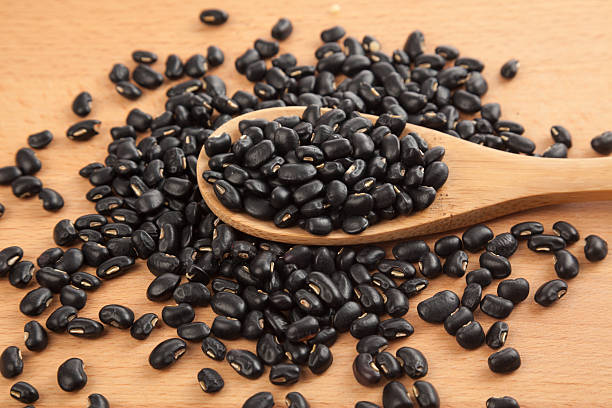 istock Black beans with wooden spoon 530182307