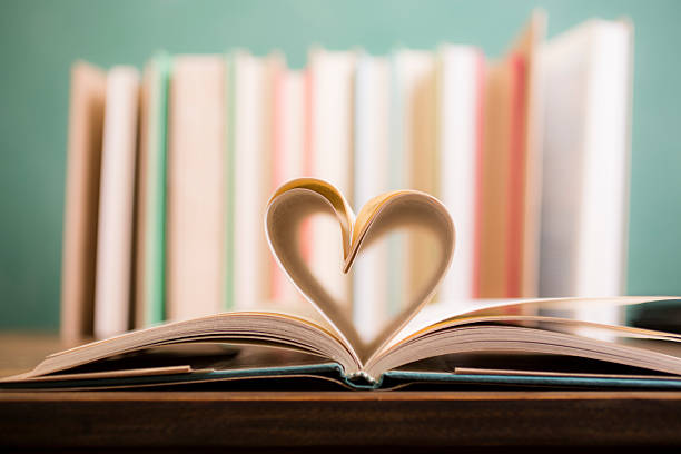 istock Love Reading!  Heart shape in open book pages. Education, school. 530183348
