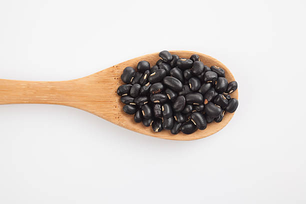 istock Black beans with wooden spoon 530183653
