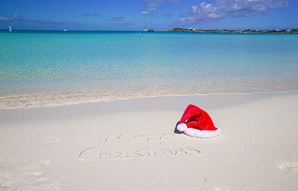 istock Merry Christmas written on tropical beach white sand 530183721