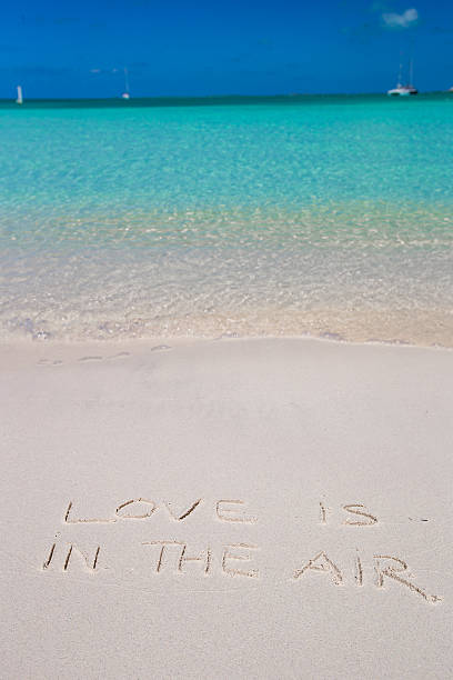 istock Love is in the air written on tropical beach 530184091