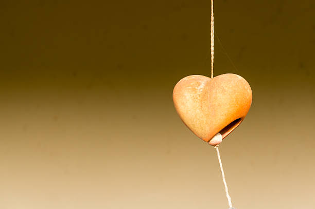 istock Old brown heart mobile hanging made from baked clay 530185126