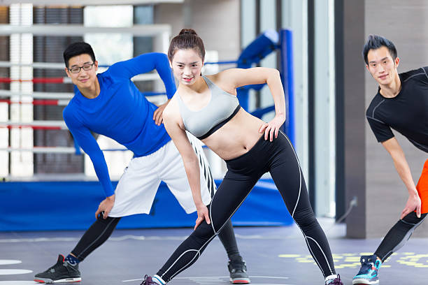 istock young asian people doing yoga in modern gym 530185784