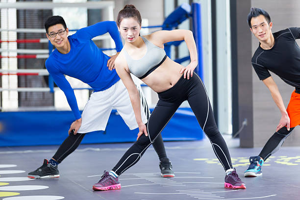 istock young asian people doing yoga in modern gym 530185830
