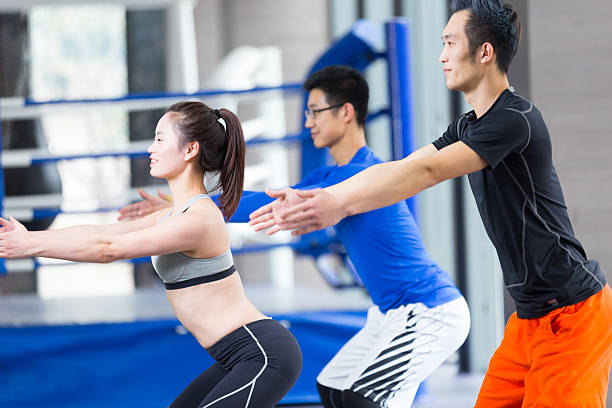 istock young asian people doing yoga in modern gym 530185872