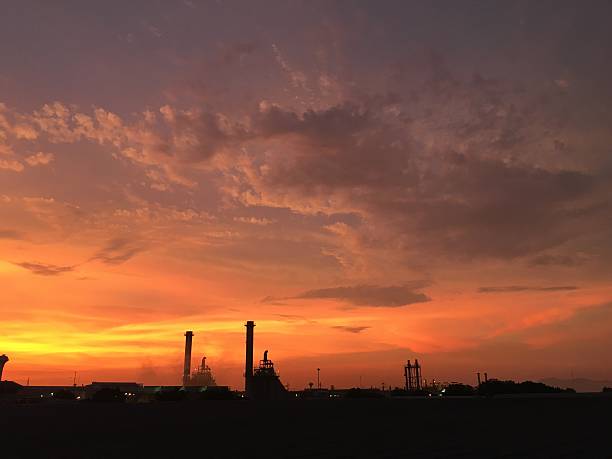 istock Industrial power plant in silhouette image at sun set. 530185972