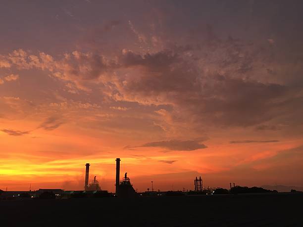 istock Industrial power plant in silhouette image at sun set. 530186002