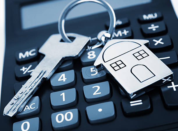 calculadora con una llave de la casa - interest rate house loan budget fotografías e imágenes de stock