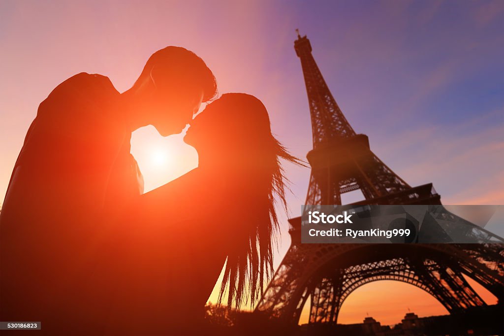 Romantic lovers with eiffel tower silhouette of romantic lovers with eiffel tower in Paris with sunset Paris - France Stock Photo