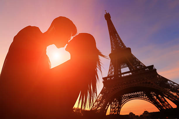Romantic lovers with eiffel tower silhouette of romantic lovers with eiffel tower in Paris with sunset paris france eiffel tower love kissing stock pictures, royalty-free photos & images