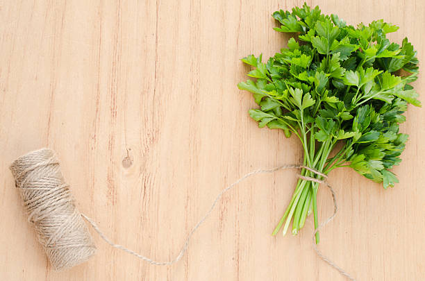 istock Organic fresh bunch of parsley on a wooden rustic table 530187438