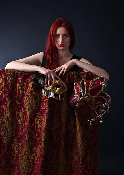 istock Beautiful redheaded woman with carnival mask 530189364