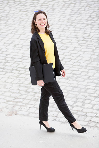 istock young woman walking and holding a book 530189414