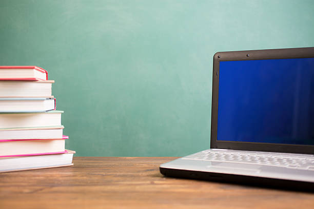 istock Back to school. Education. Textbooks, laptop computer on desk. Chalkboard. 530189738