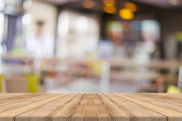istock Wooden board empty table blur in coffee shop. 530192634