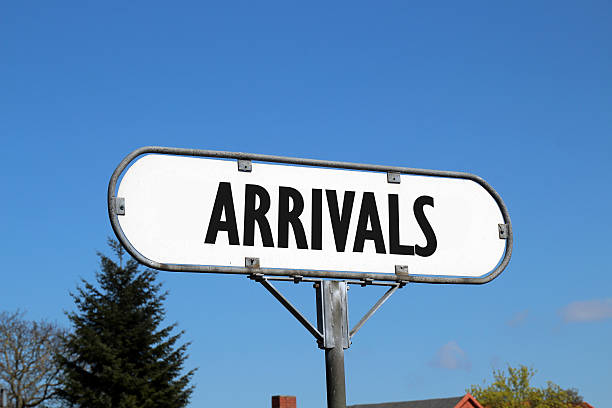 istock arrivals - white metal sign on blue sky background 530193200