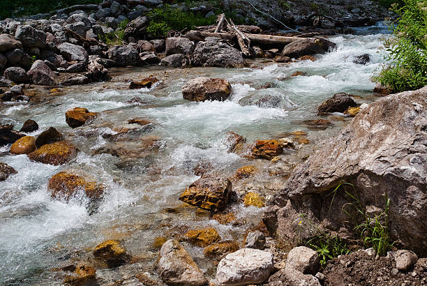 istock Mountain stream flowing over yellow rocks 530193208