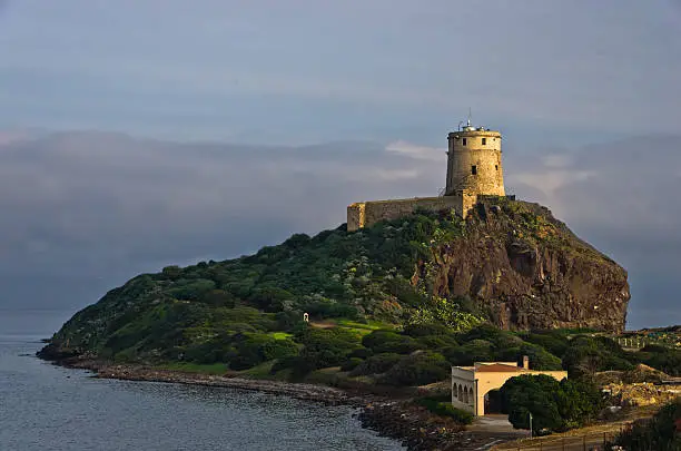 Tower Coltellazzo of Saint Efisio lighthouse at Nora archeological site, gulf of Cagliari, Sardinia, Italy