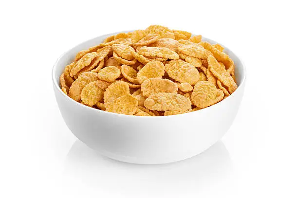 Photo of Bowl with cornflakes isolated on white background.